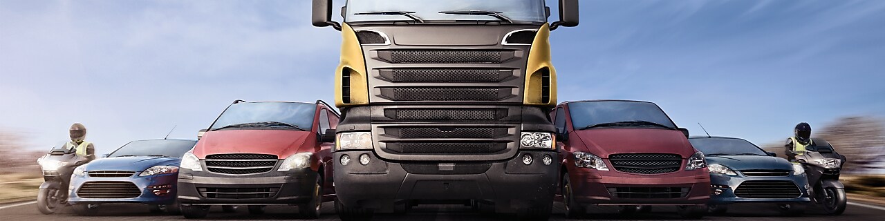 Motorcycles, cars and trucks on road