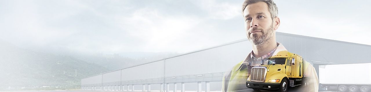 man reading a document transposed onto a background of a site and yellow truck