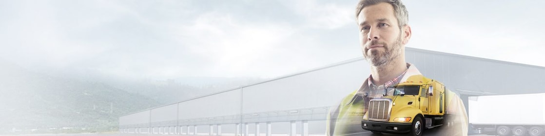 man reading a document transposed onto a background of a site and yellow truck