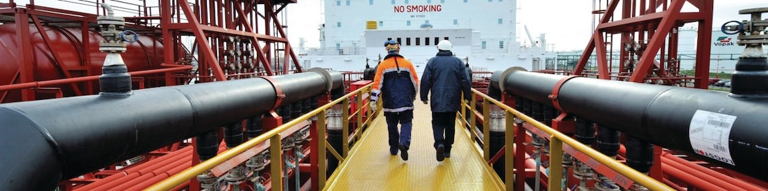 Shell employee walking along on a tanker