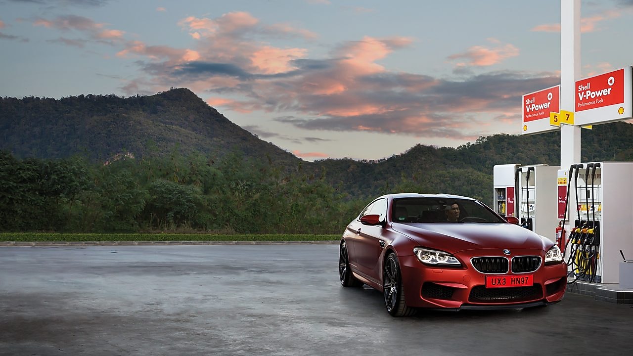 Red car in Shell forecourt