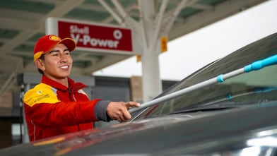 Red car in Shell forecourt