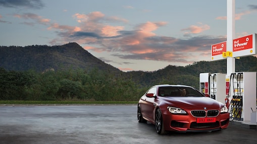 Red car in Shell forecourt