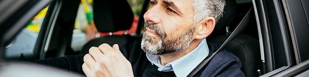 hombre en auto con cinturon de seguridad