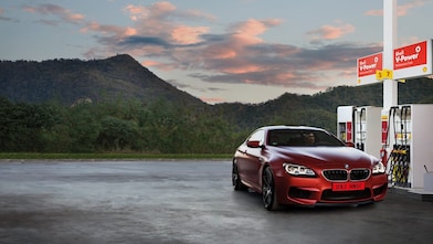 Red car in Shell forecourt